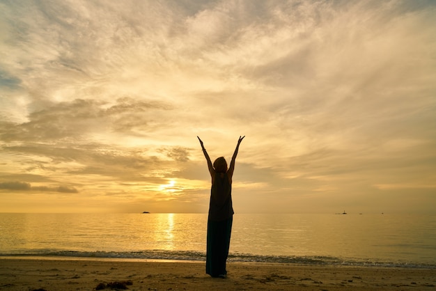 Free photo yoga and woman on the beach