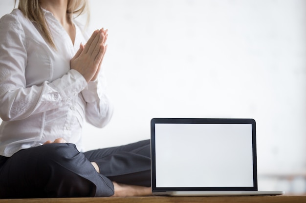 Yogi businesswoman with copy space laptop