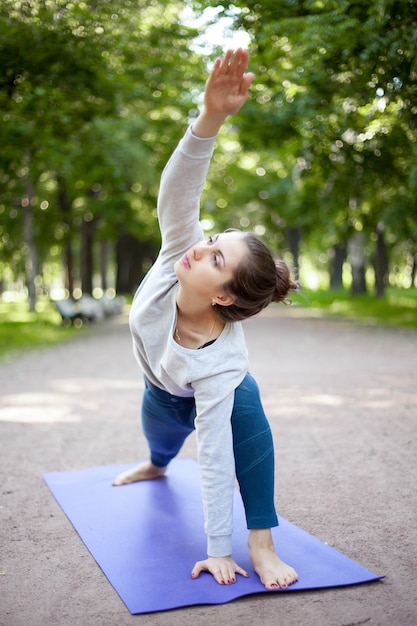 Девочка-йоги в расширенной боковой угловой позе