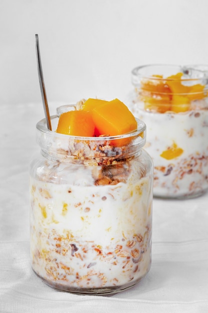 Foto gratuita vasetti di yogurt con disposizione di frutta