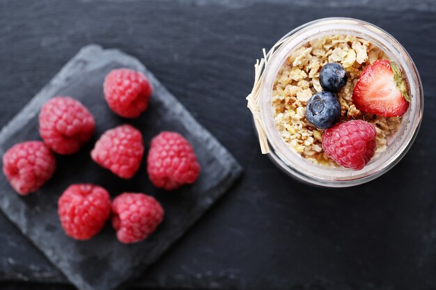 Yogurt with oatmeal and berries in glass