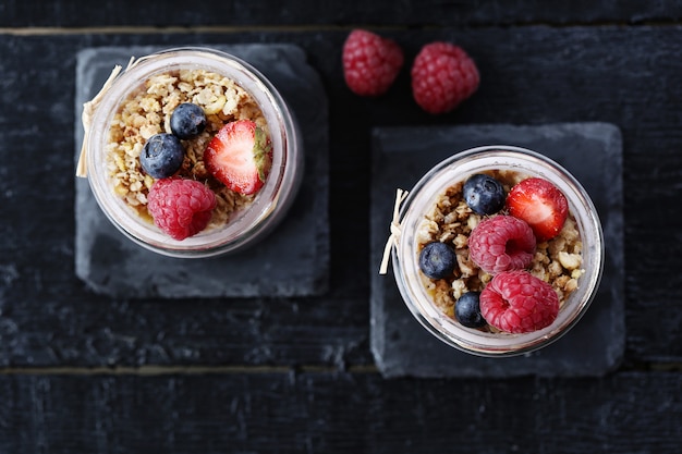 Yogurt with oatmeal and berries in glasses