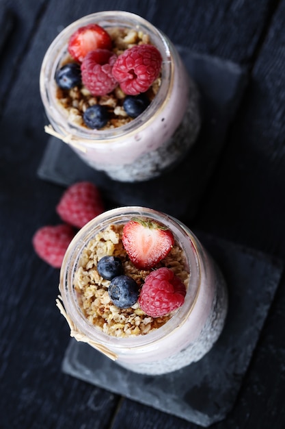 Yogurt with oatmeal and berries in glasses