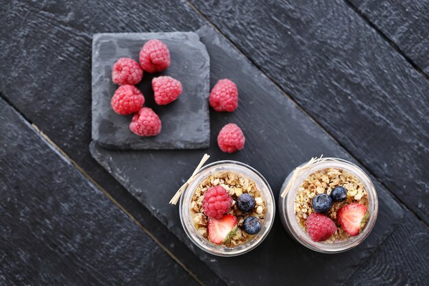 Yogurt with oatmeal and berries in glasses