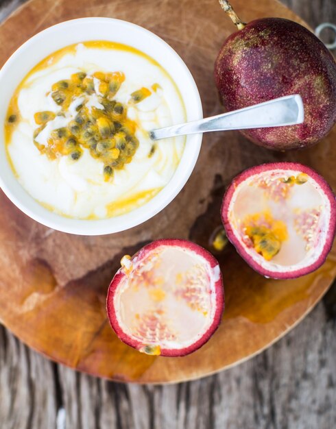 Yogurt with passion fruit in a white bowl