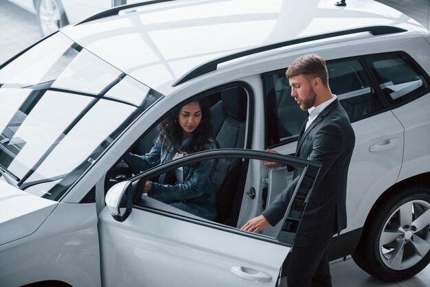 you will feel comfort. female customer and modern stylish bearded businessman in the automobile saloon