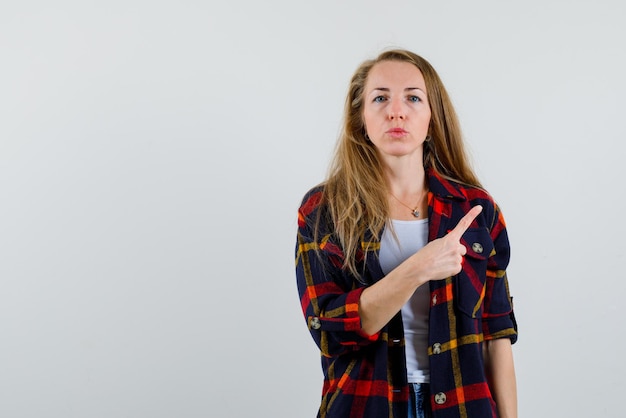 Yougn woman showing the right with her finger on white background