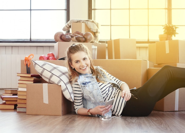 Yougn woman unpacking boxes