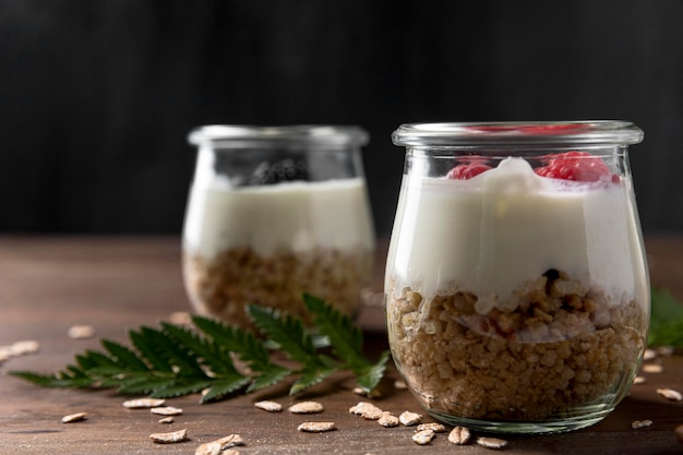 Yougurt with granola cereals and fruits on desk