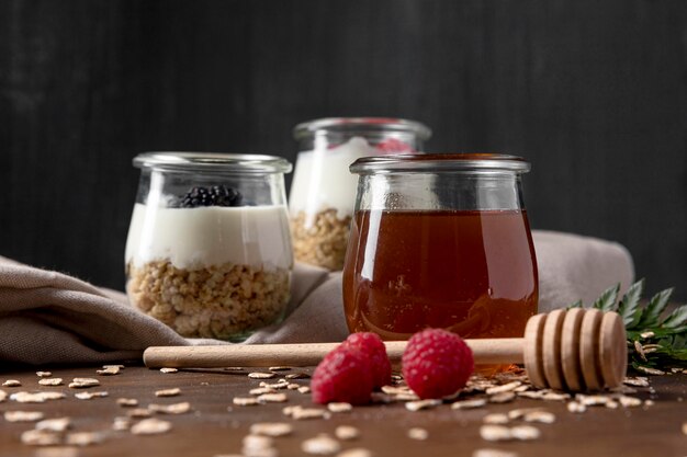 Yougurt with granola cereals and fruits on table