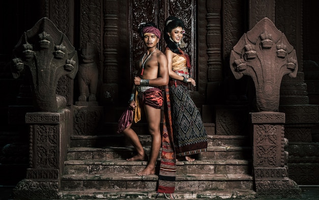 Free photo young actor and actress wearing beautiful ancient costumes, in ancient monuments, dramatic style. perform on legend love popular story, thai isan folktale called 