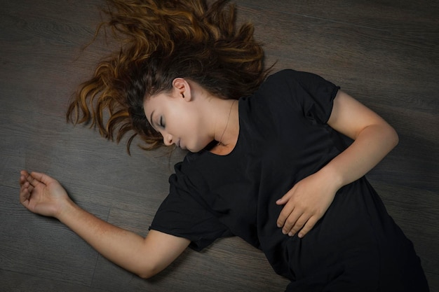 Free photo young addicted girl laying on the ground. high quality photo