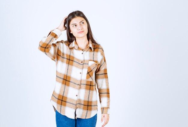 Young adorable girl in casual outfit posing thinking.