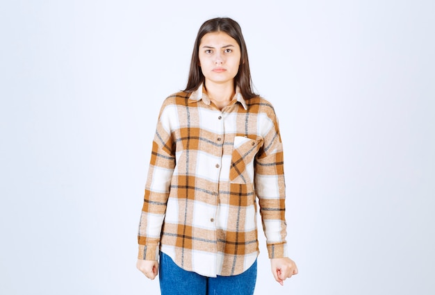 Free photo young adorable woman feeling sad on white wall.