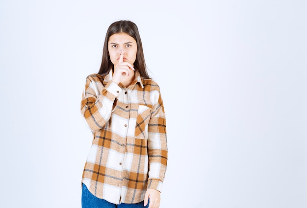  young adorable woman standing on white wall. 