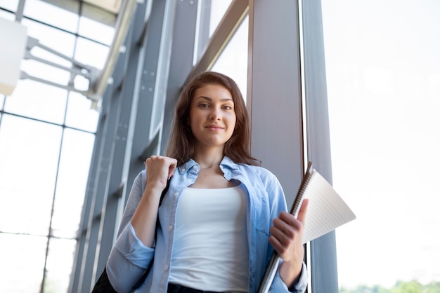 young adult checking her notes