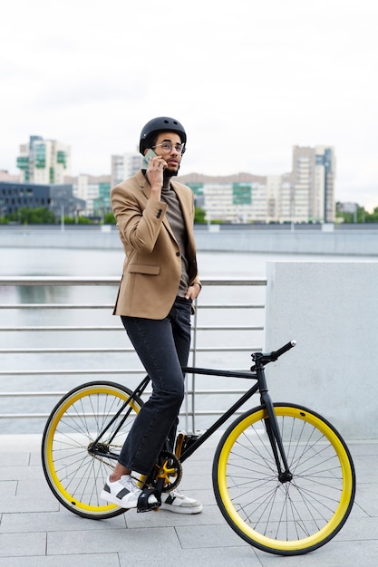 Free photo young adult cycling to work in the city