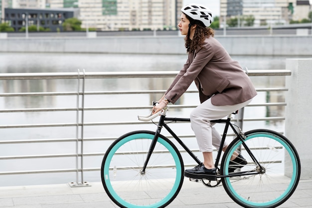 Young adult cycling to work in the city