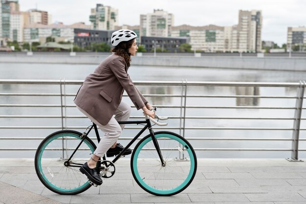 Young adult cycling to work in the city