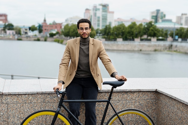 Young adult cycling to work in the city