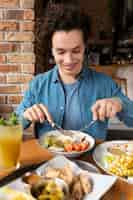 Free photo young adult enjoying food