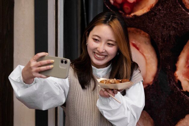 Young adult enjoying japanese street food