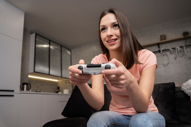 Free photo young adult enjoying playing video game