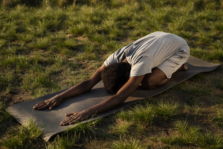 Free Photo young adult enjoying yoga in nature