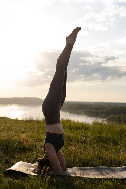 Young adult enjoying yoga in nature