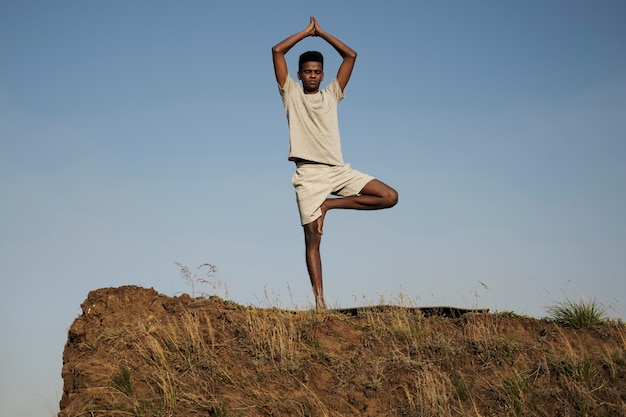 Young adult enjoying yoga in nature