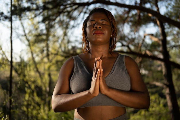 Young adult enjoying yoga in nature