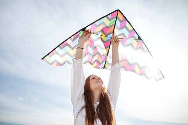 Young adult having fun with kite