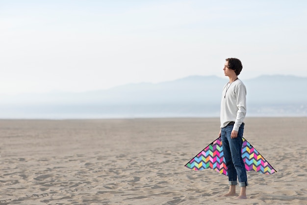 Young adult having fun with kite