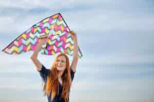 Free photo young adult having fun with kite