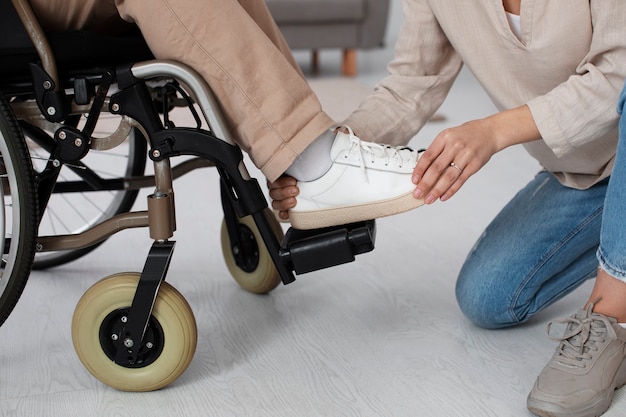 Young adult helping disabled friend