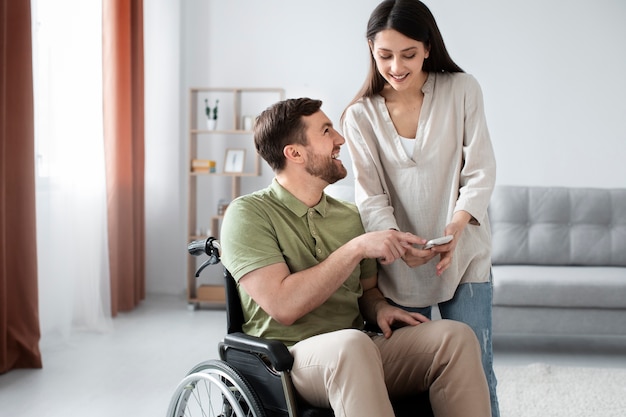 Young adult helping disabled friend