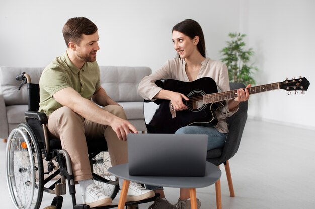 Young adult helping disabled friend