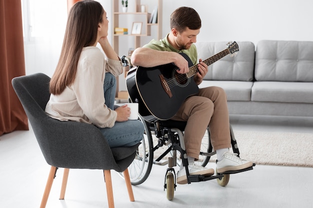 Young adult helping disabled friend