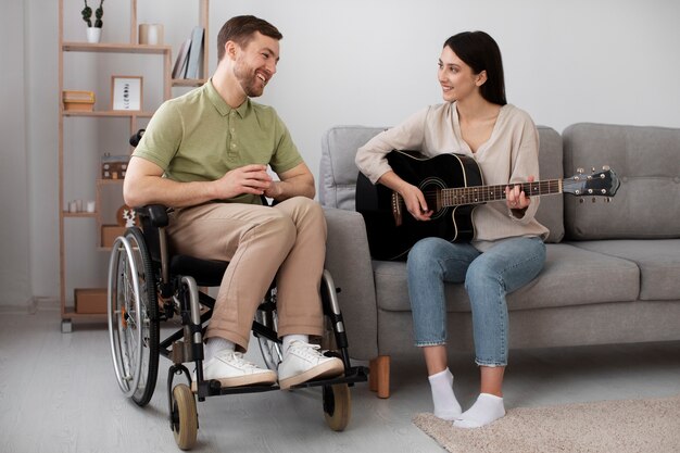 Young adult helping disabled friend