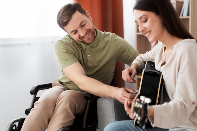 Young adult helping disabled friend