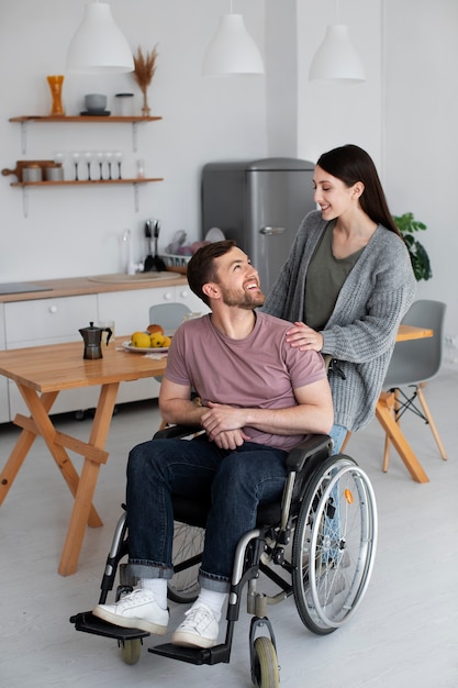 Young adult helping disabled friend