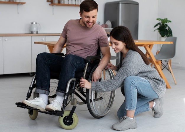 Young adult helping disabled friend