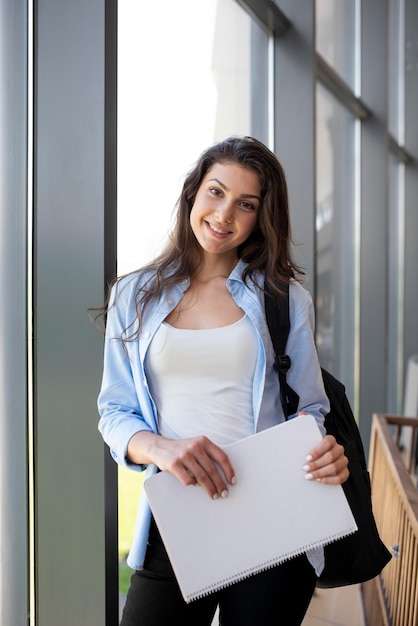 Free photo young adult holding her notebook