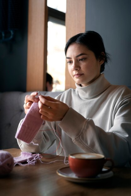 Young adult knitting outside