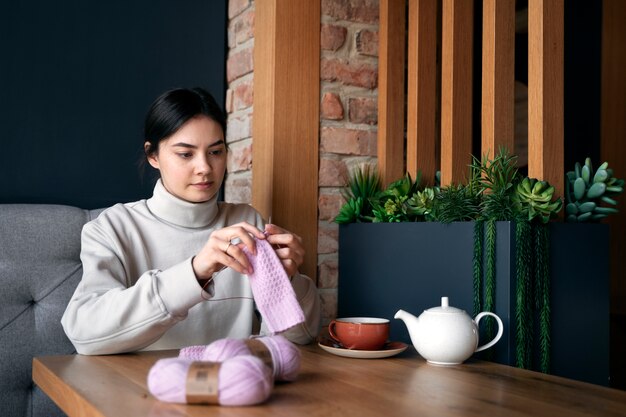 Young adult knitting outside