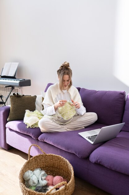 Young adult knitting together