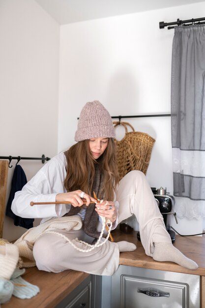 Young adult knitting together