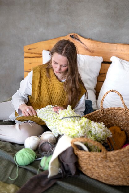 Young adult knitting together