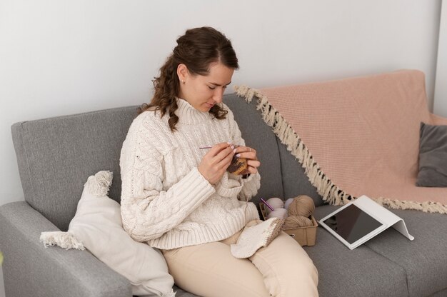 Young adult organizing their knitting products