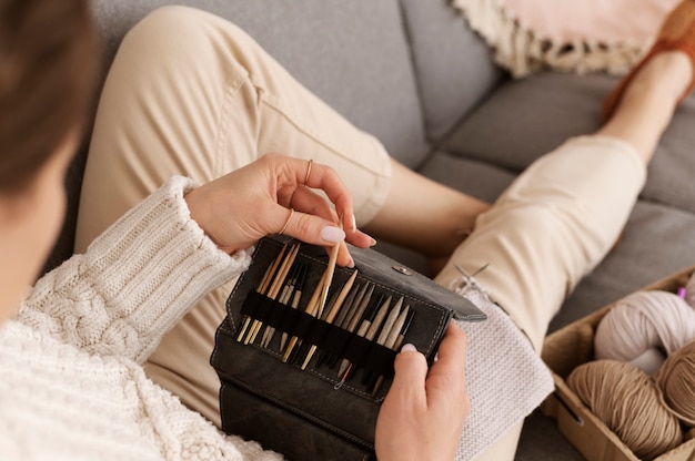 Young adult organizing their knitting products